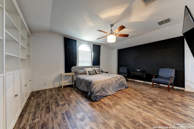 bedroom featuring ceiling fan, wood-type flooring, and vaulted ceiling