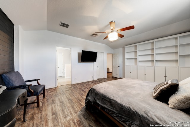 bedroom with ceiling fan, wood-type flooring, and vaulted ceiling