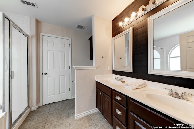 bathroom with walk in shower, dual vanity, and tile patterned floors