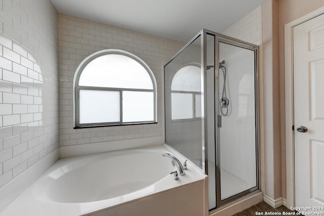 bathroom with shower with separate bathtub