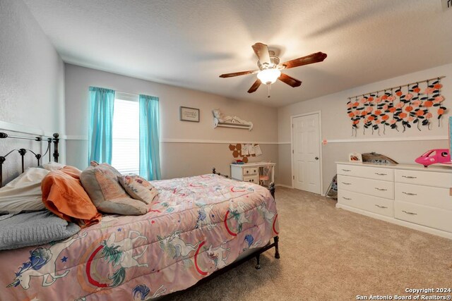 bedroom featuring light carpet and ceiling fan