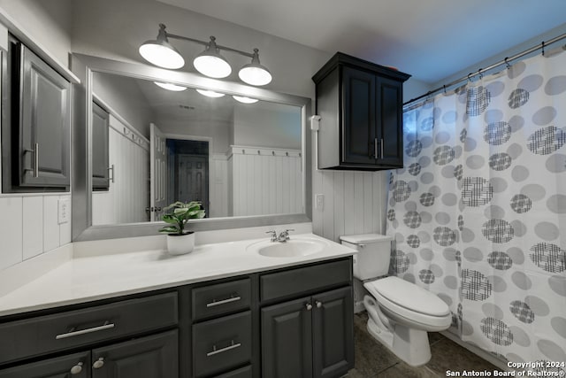 bathroom featuring vanity, tile patterned floors, and toilet