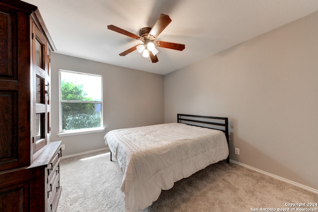 bedroom with light carpet and ceiling fan