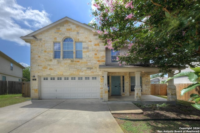 view of front of property with a garage and covered porch