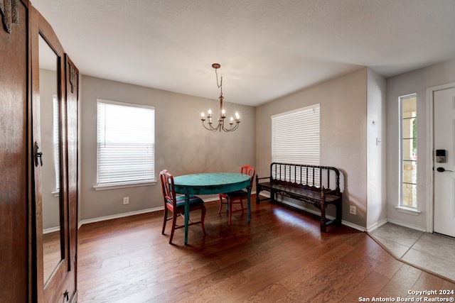 dining area featuring an inviting chandelier and hardwood / wood-style flooring