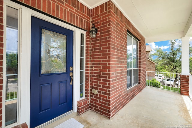 entrance to property featuring covered porch