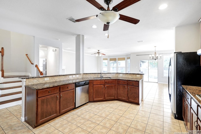 kitchen with a center island, sink, dark stone counters, and appliances with stainless steel finishes