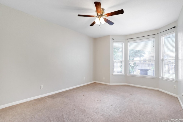 carpeted empty room with ceiling fan