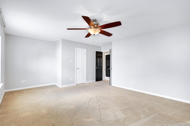 carpeted empty room featuring ceiling fan