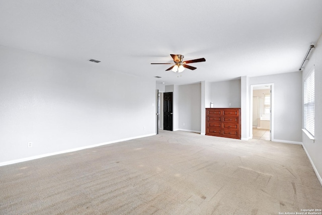 unfurnished room featuring light colored carpet and ceiling fan