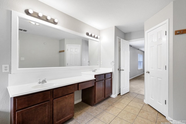 bathroom featuring tile patterned flooring and vanity