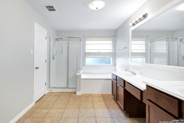 bathroom featuring tile patterned floors, plus walk in shower, and vanity