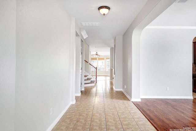 hall featuring light tile patterned floors