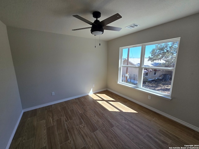 unfurnished room featuring dark hardwood / wood-style floors, a textured ceiling, and ceiling fan