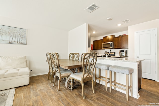 dining room with light hardwood / wood-style flooring