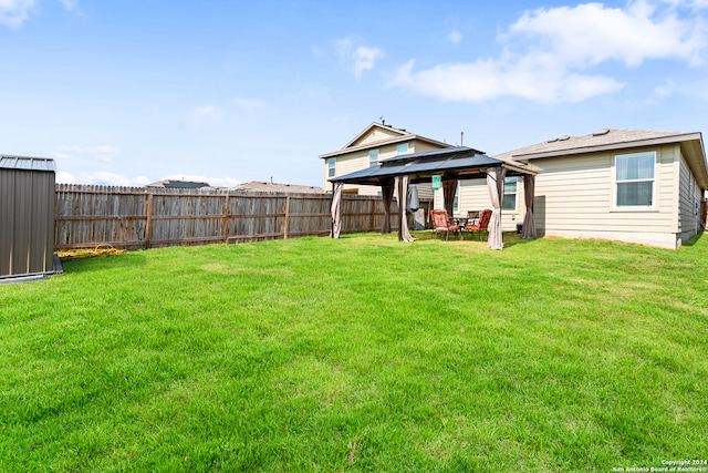 rear view of house featuring a patio, a yard, and a gazebo