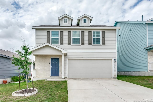 view of front of house featuring a garage and a front lawn