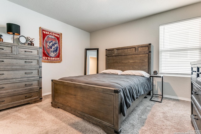 carpeted bedroom featuring a textured ceiling