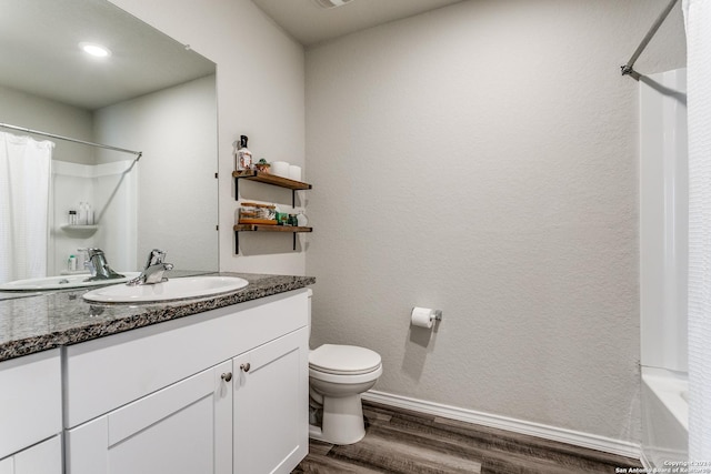 bathroom featuring vanity, toilet, and hardwood / wood-style floors