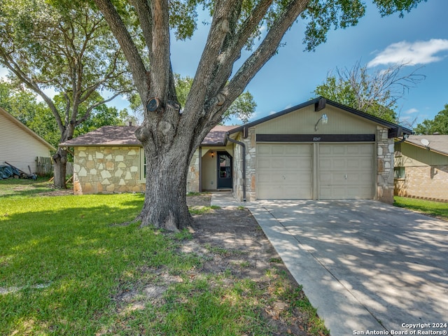 ranch-style home with a garage and a front lawn