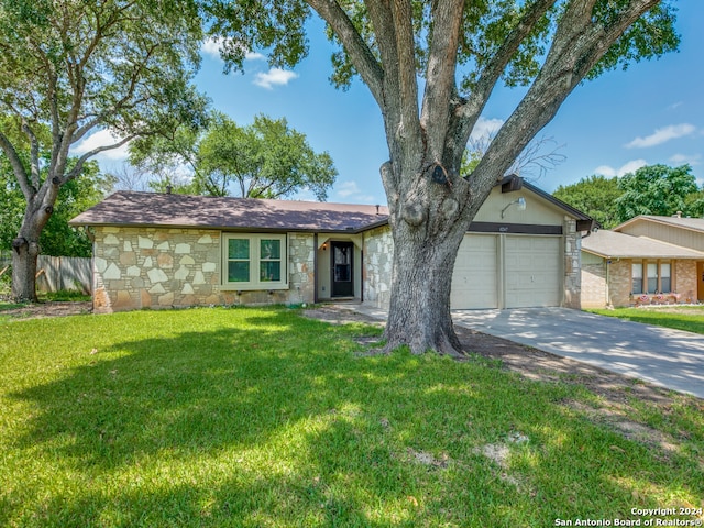 ranch-style house featuring a garage and a front yard