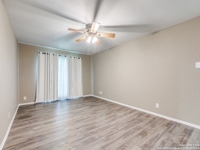 spare room featuring ceiling fan and hardwood / wood-style flooring