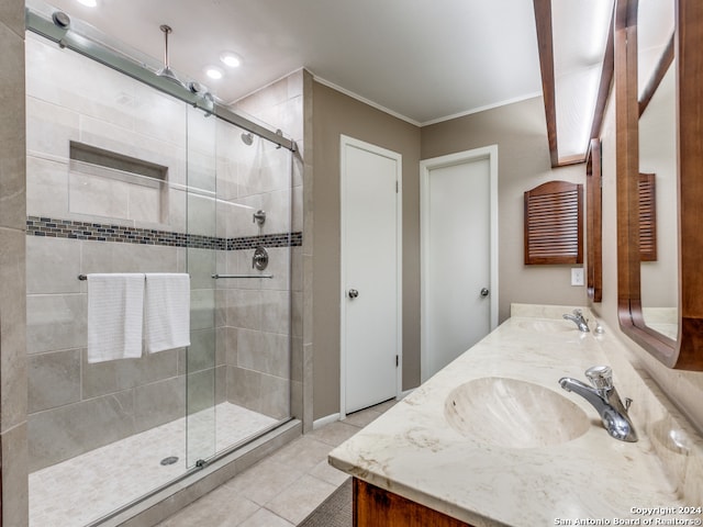 bathroom with ornamental molding, tile patterned floors, walk in shower, and dual bowl vanity