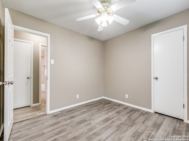 spare room with ceiling fan and light wood-type flooring