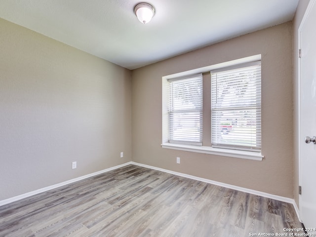 spare room with hardwood / wood-style flooring