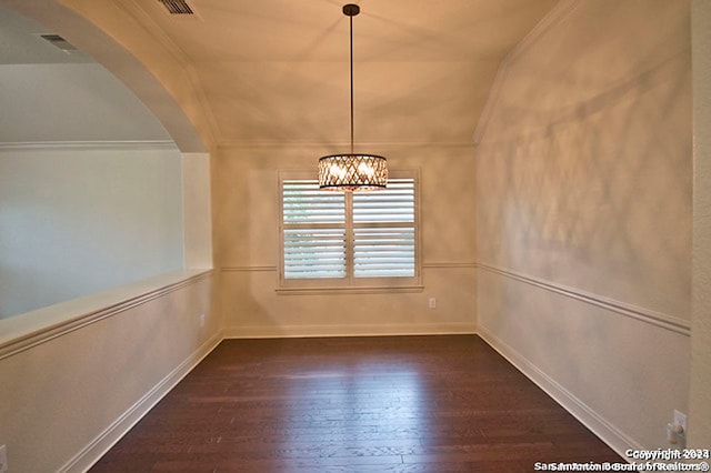 unfurnished dining area with an inviting chandelier, lofted ceiling, crown molding, and dark hardwood / wood-style floors