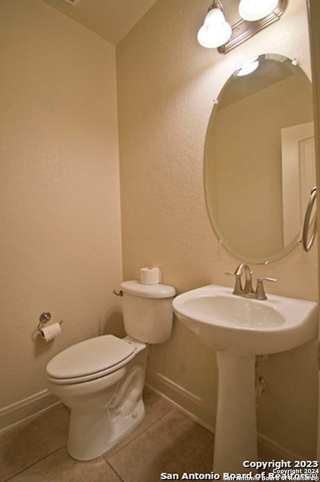 bathroom featuring tile patterned flooring and toilet