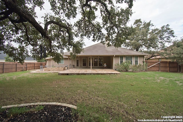 rear view of property with a patio area and a yard