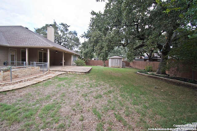 view of yard with a storage shed and a patio