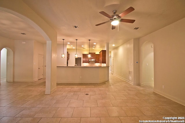 kitchen with kitchen peninsula, light tile patterned floors, backsplash, and ceiling fan