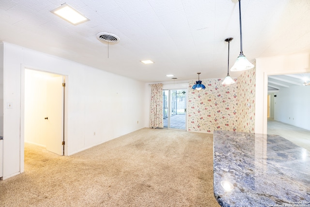 unfurnished living room featuring light colored carpet