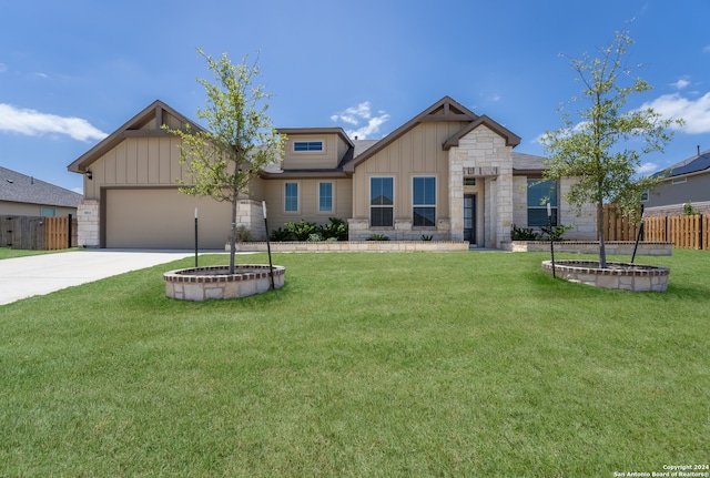 craftsman-style house featuring a garage and a front yard