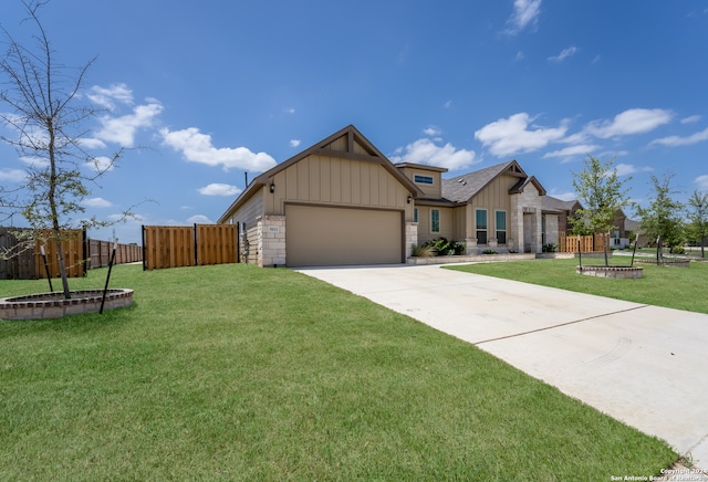 craftsman-style home featuring a garage and a front lawn