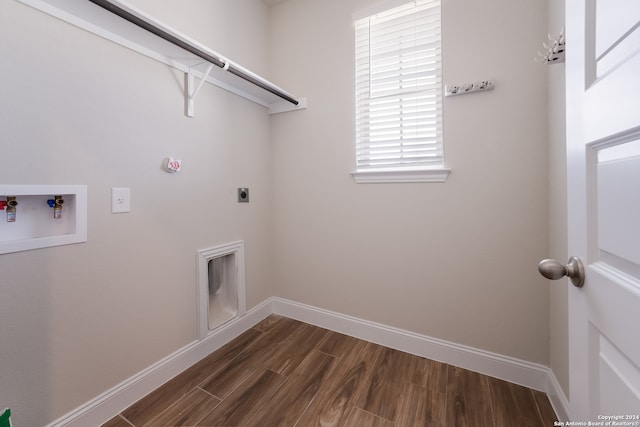 laundry area featuring hookup for a washing machine, dark wood-type flooring, and hookup for an electric dryer