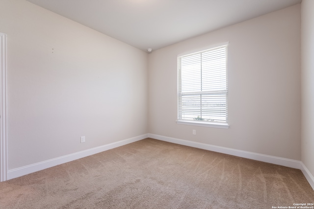 empty room featuring light colored carpet