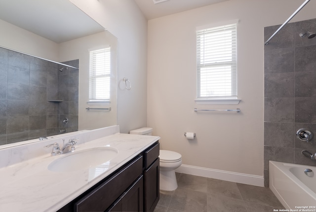 full bathroom featuring tiled shower / bath, vanity, a wealth of natural light, and tile patterned flooring