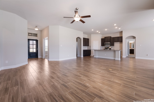 unfurnished living room featuring light wood-type flooring and ceiling fan