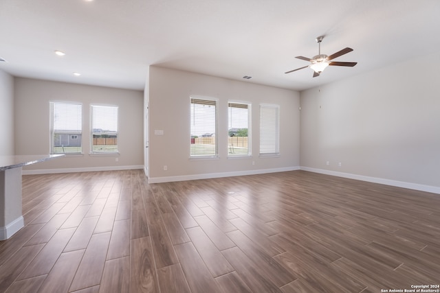 unfurnished living room with hardwood / wood-style flooring and ceiling fan