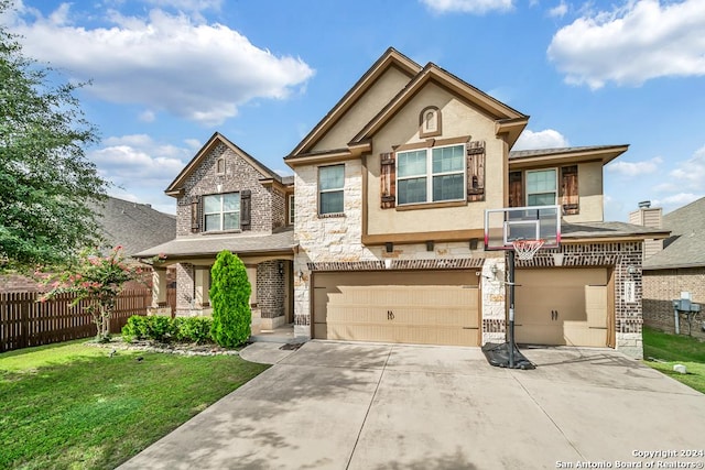 view of front of home with a garage, driveway, stone siding, fence, and a front lawn