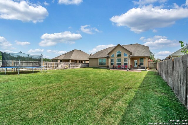 view of yard with a patio and a trampoline