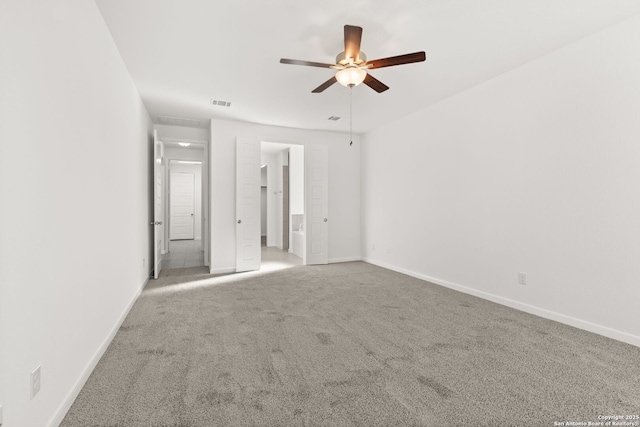 unfurnished bedroom with visible vents, baseboards, a ceiling fan, connected bathroom, and carpet