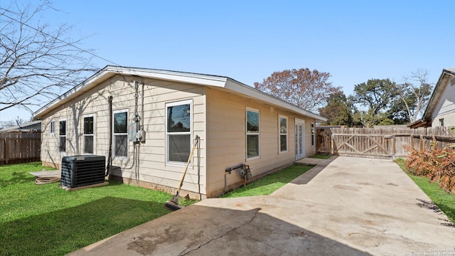 view of property exterior featuring central AC, a patio area, and a lawn