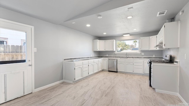 kitchen featuring white cabinetry, appliances with stainless steel finishes, and sink