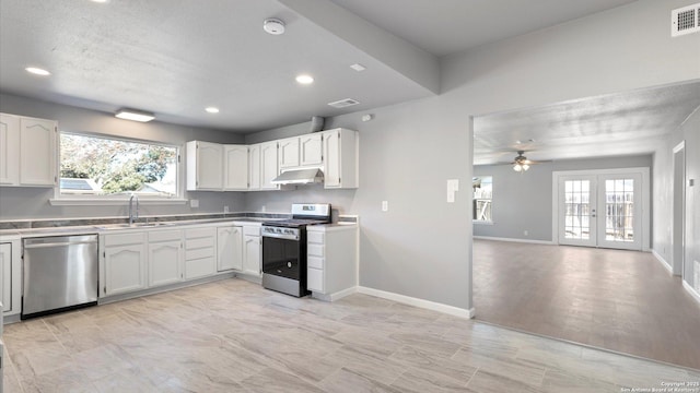 kitchen with stainless steel appliances, plenty of natural light, sink, and white cabinets