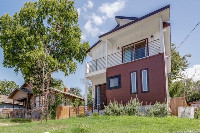 exterior space with a balcony and a yard