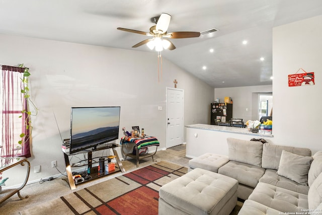 living room featuring vaulted ceiling, light colored carpet, and ceiling fan